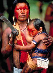 Breastfeeding tribal woman with machete
